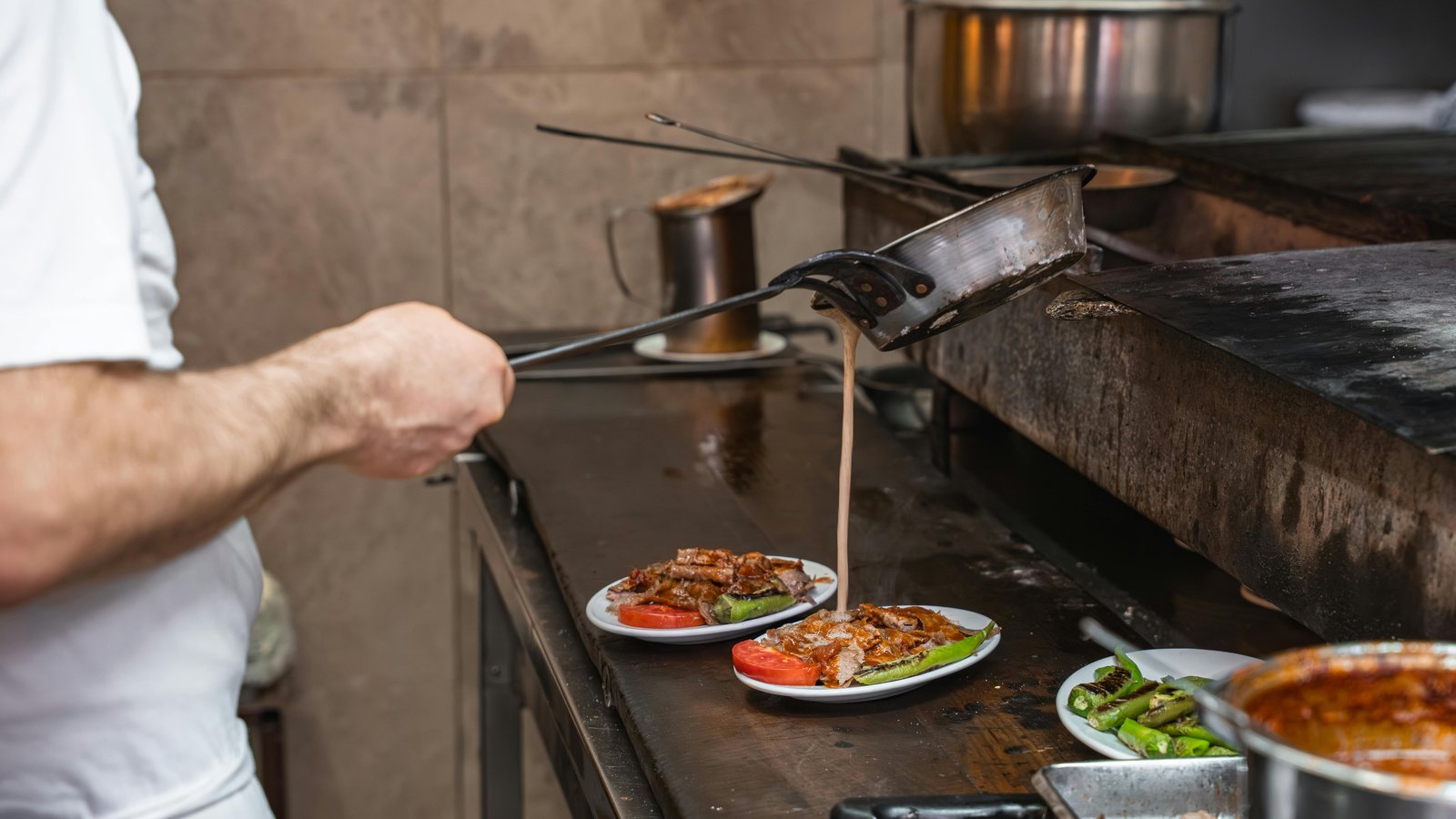 Chef Steve Ingber plating a multi-course dinner in a private Denver home kitchen