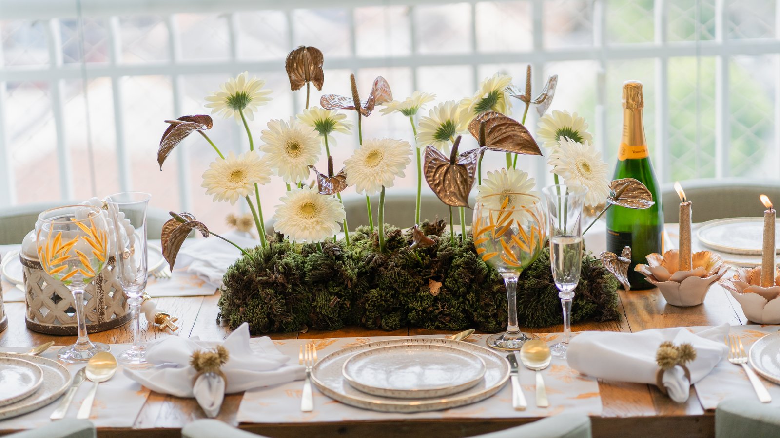 Elegant plated appetizer on a candlelit holiday dining table with champagne flutes nearby.