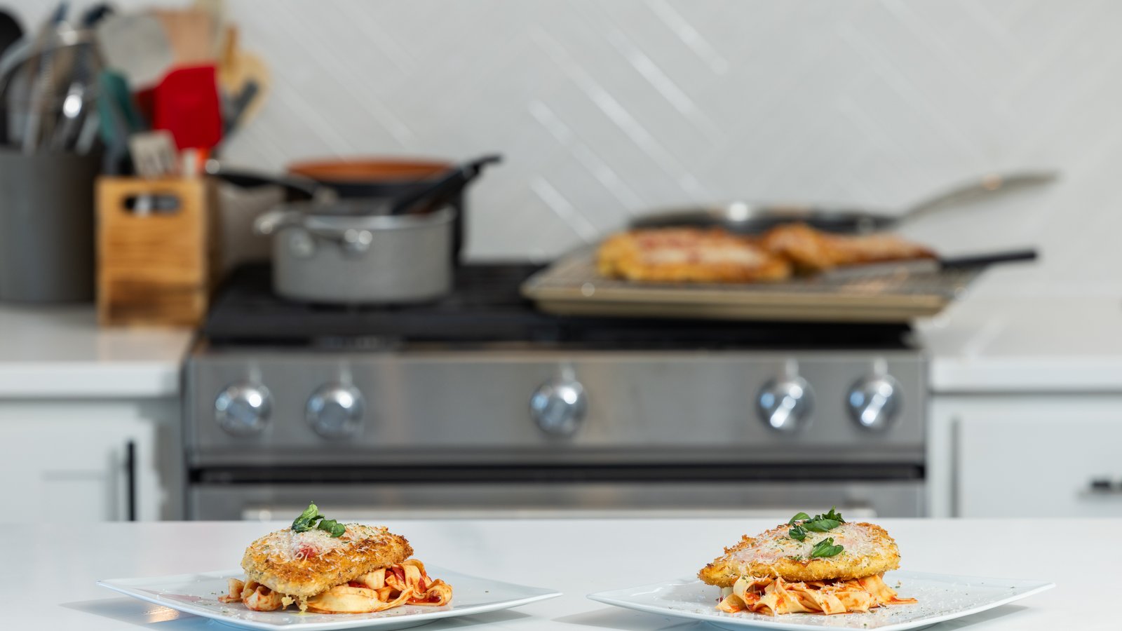 Elegantly plated course being finished in a Denver home kitchen during a one-night private chef dinner.