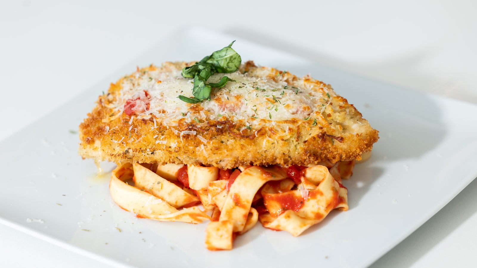 Golden herb-crusted fish fillet plated for a summer group dinner at a Vail vacation rental.