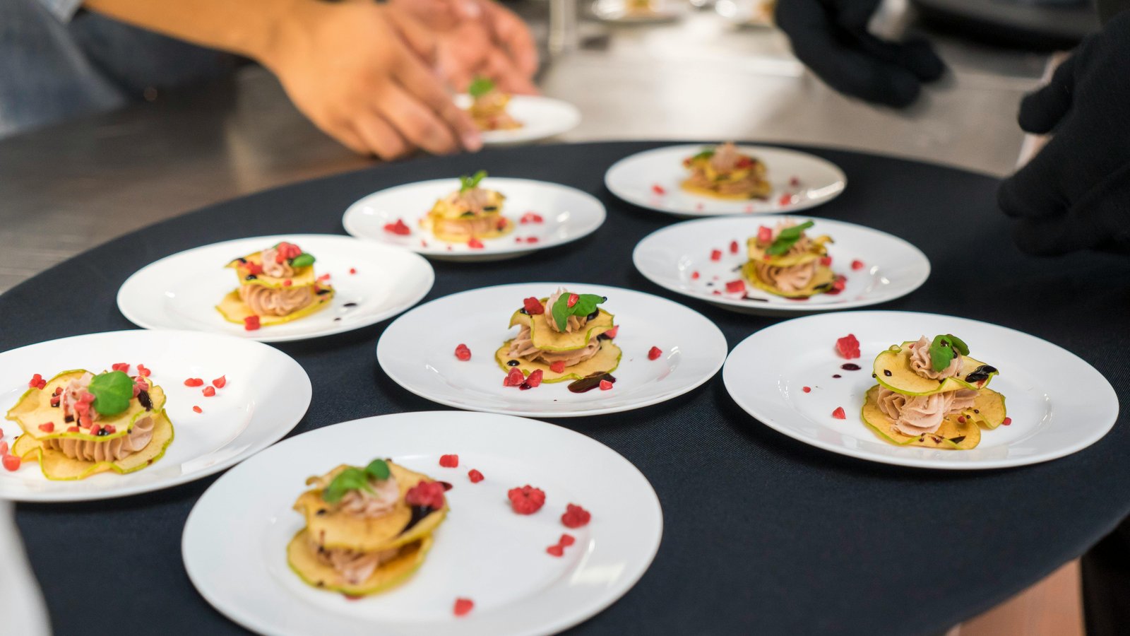 Chef Steve Ingber plating an elegant dish at the 35th Annual Taste of Vail competition.