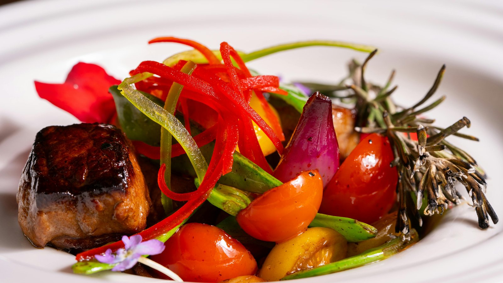 Chef Steve Ingber plating vibrant vegetables and whole grains on fine dishware, rejecting processed substitutes.
