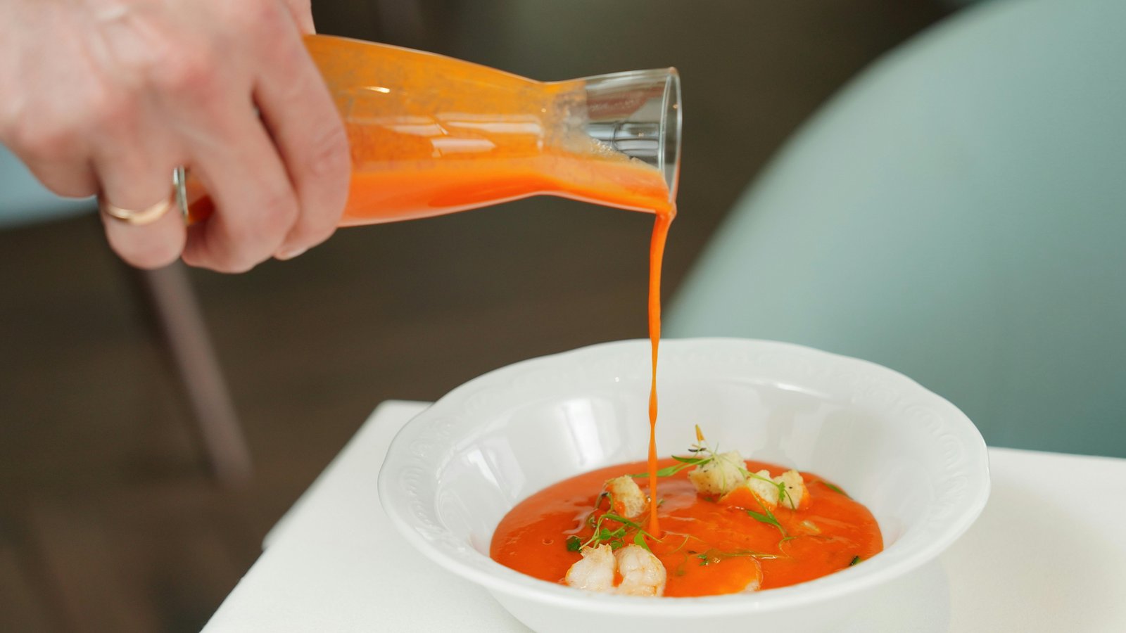 Chef preparing an elegant plated course in a sophisticated Denver home dining room.