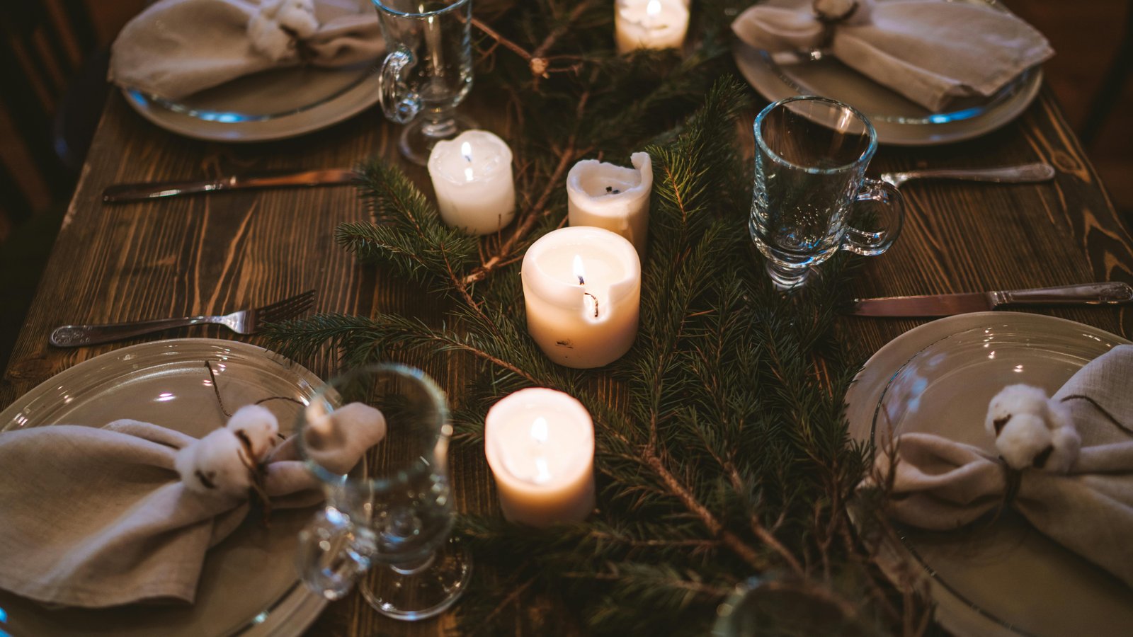 An intimate dinner table set for six with plated courses and candlelight in a Denver home.