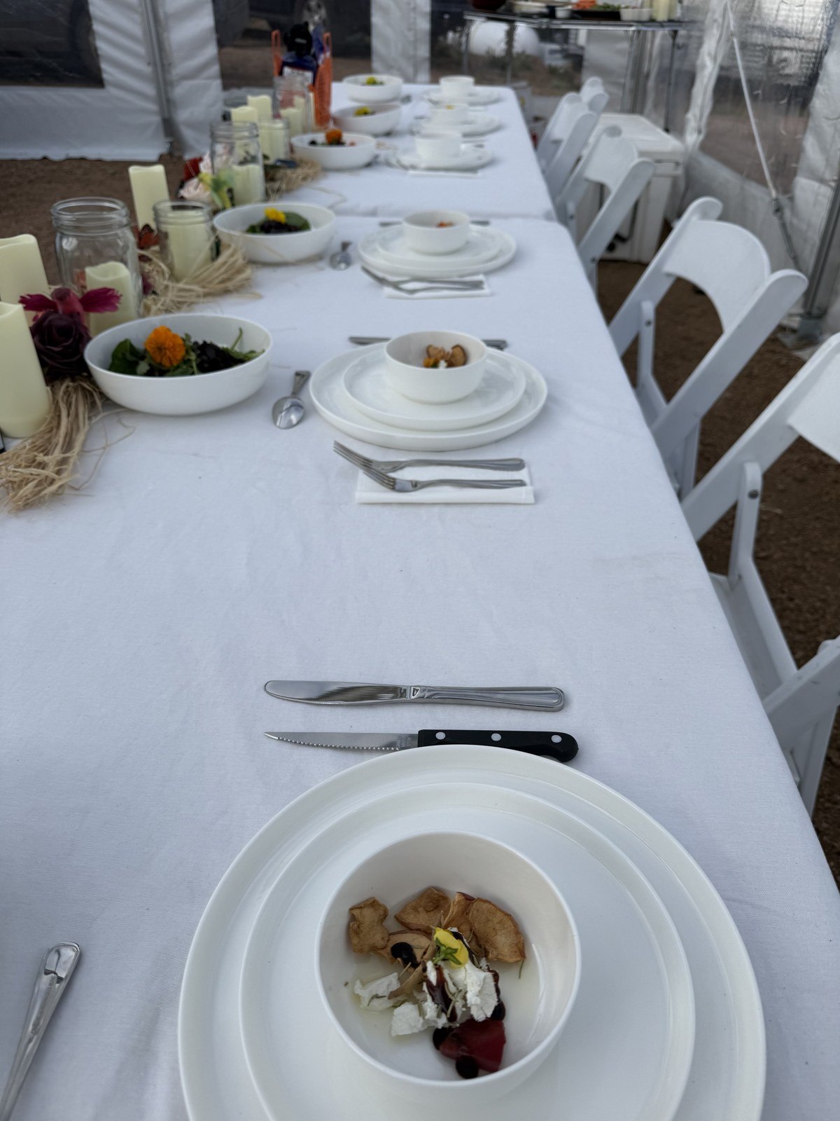 Dinner table set with white linen for a private event