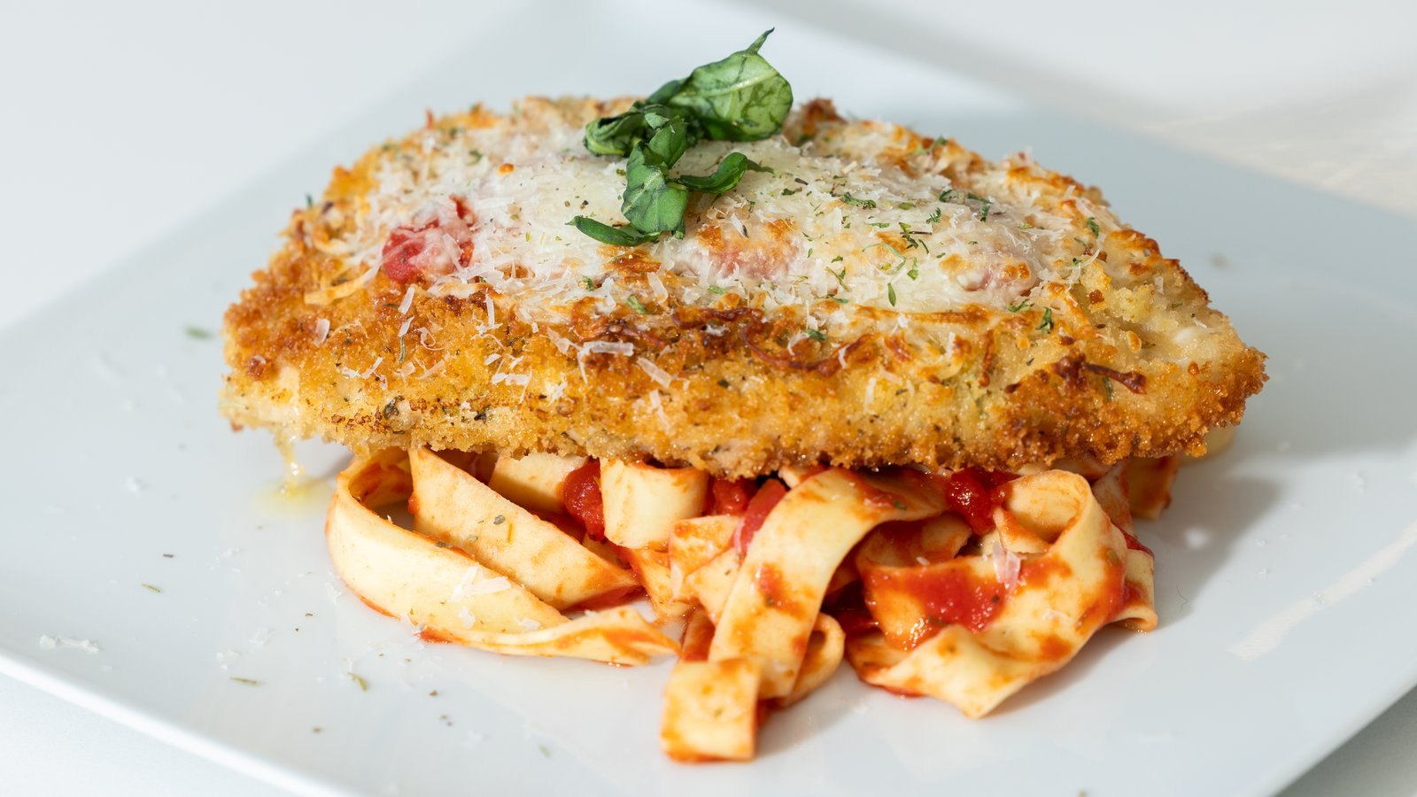 Chicken parmesan over fresh pasta