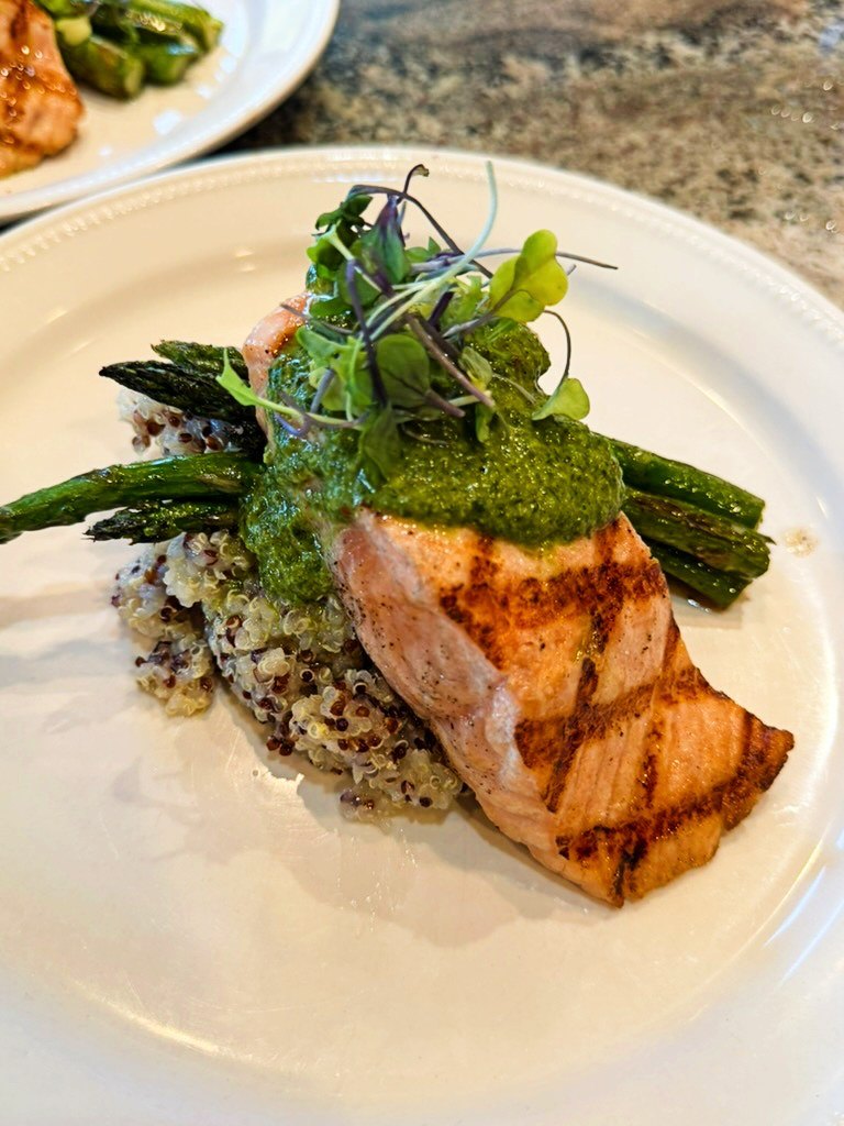 Grilled salmon over quinoa with asparagus, a meal prep dinner