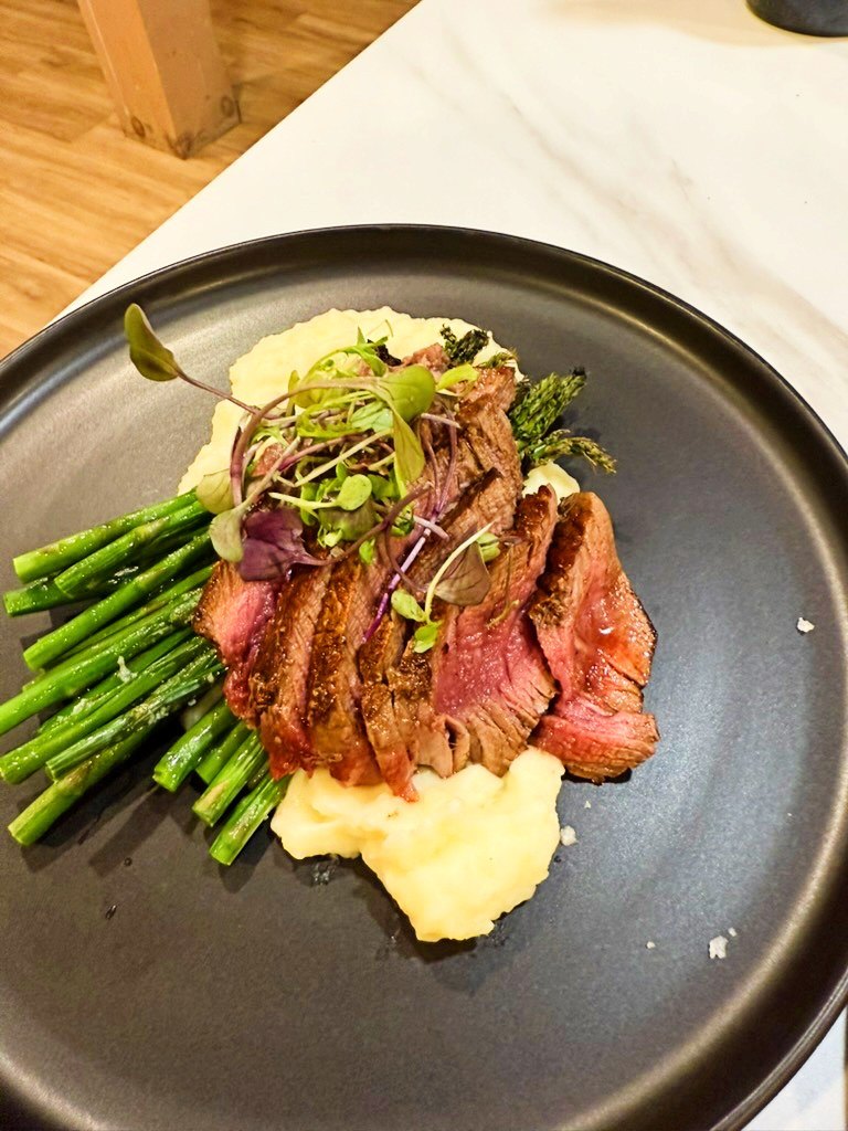 Seared steak over potato puree with asparagus