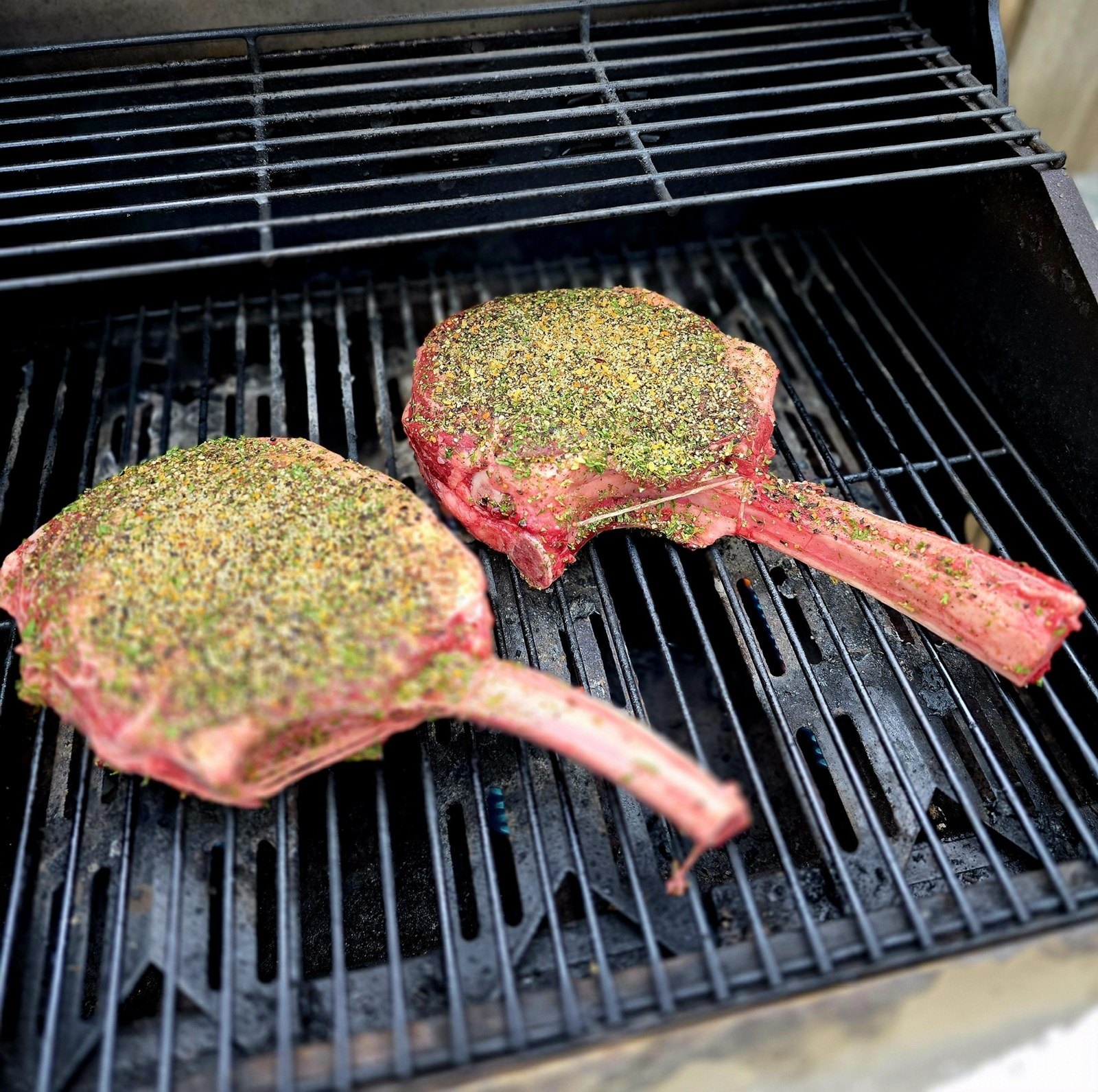 Herb-crusted tomahawk steaks on the grill
