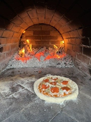 Pizza in a wood-fired oven