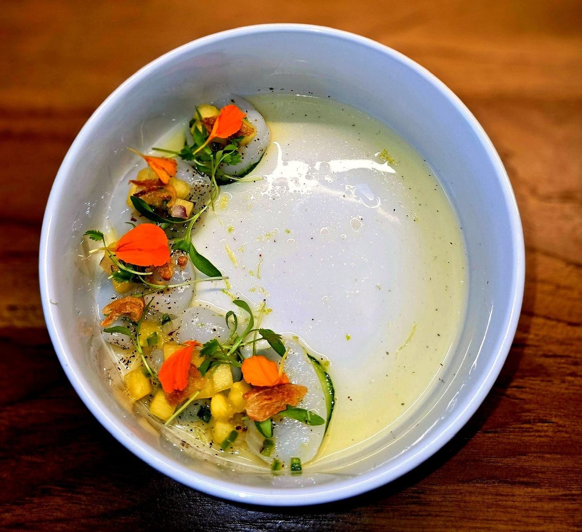 Seafood crudo with edible flowers from a seven-course Aspen tasting menu