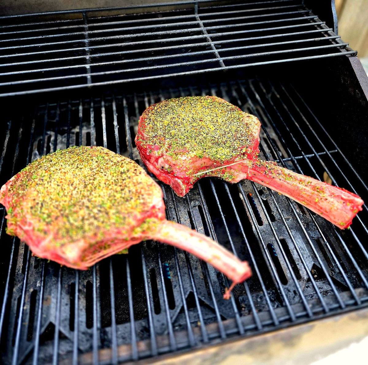 Herb-crusted tomahawk steaks on the grill at a Scottsdale corporate retreat